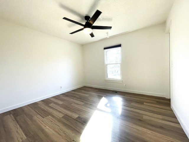 empty room with ceiling fan, a textured ceiling, and dark hardwood / wood-style flooring