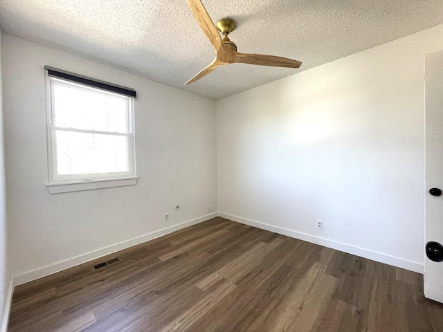 unfurnished room with a textured ceiling, ceiling fan, and dark hardwood / wood-style floors