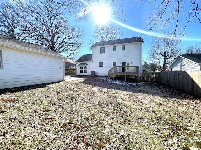 rear view of property with a deck and cooling unit