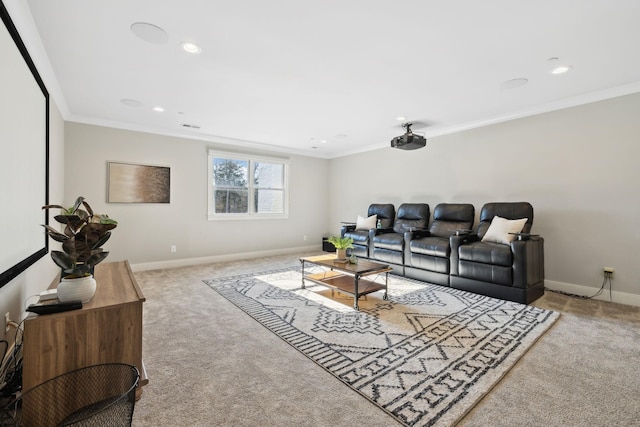 carpeted home theater room featuring ornamental molding