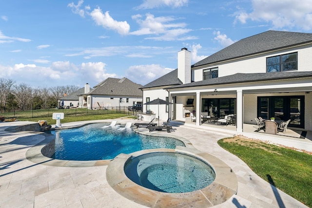 view of swimming pool with a patio and an in ground hot tub