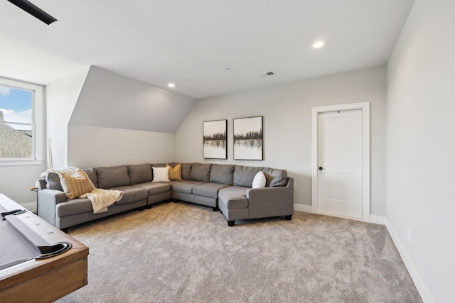 carpeted living room featuring lofted ceiling