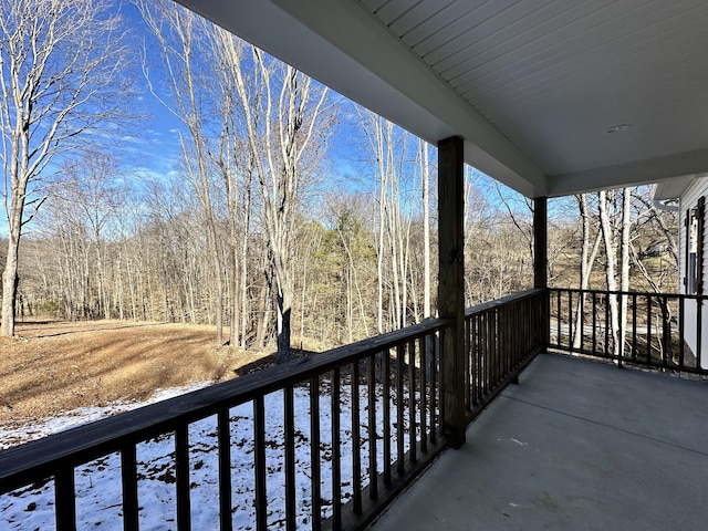 view of snow covered back of property