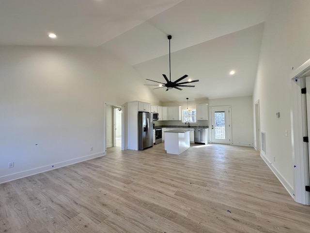 kitchen featuring light hardwood / wood-style floors, white cabinets, a center island, and stainless steel appliances