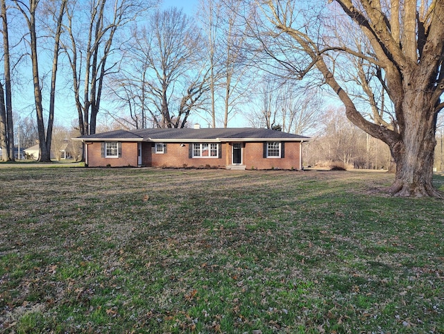 ranch-style house with a front yard and brick siding