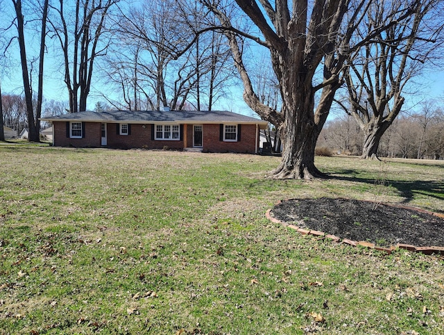 single story home featuring a front lawn and brick siding