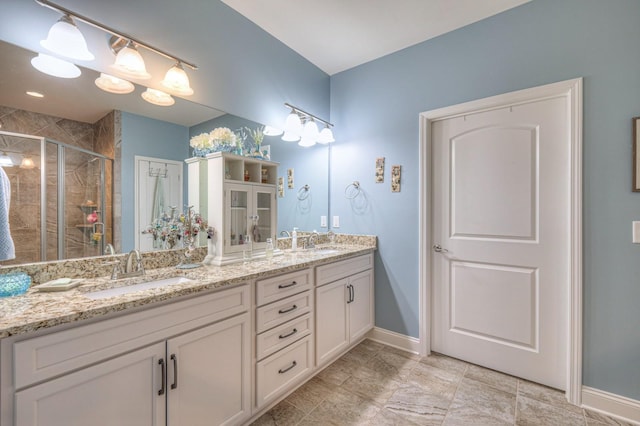 bathroom featuring vanity and a shower with door