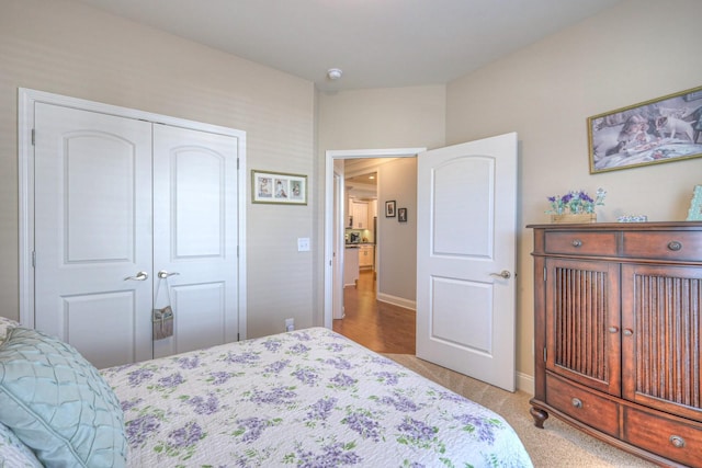 bedroom featuring a closet and light carpet