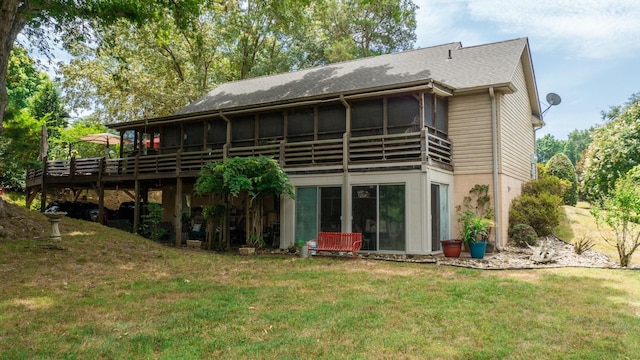 rear view of property with a sunroom and a yard