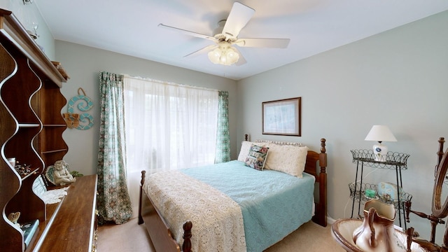 bedroom featuring ceiling fan and light carpet