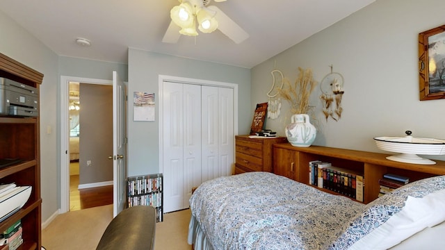 carpeted bedroom featuring ceiling fan and a closet