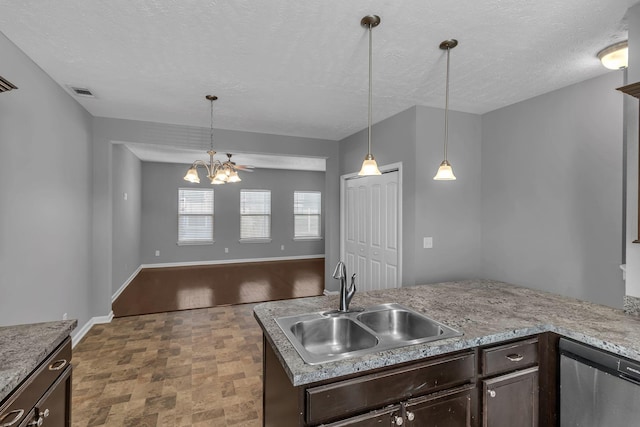 kitchen with hanging light fixtures, stainless steel dishwasher, dark brown cabinetry, and sink