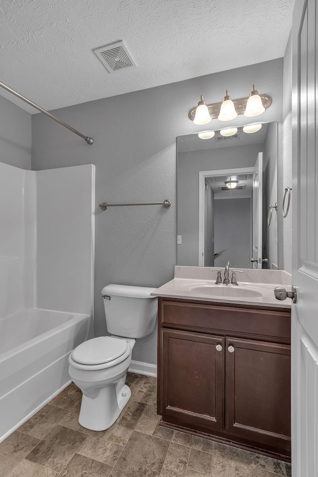 full bathroom with toilet, bathing tub / shower combination, a textured ceiling, and vanity