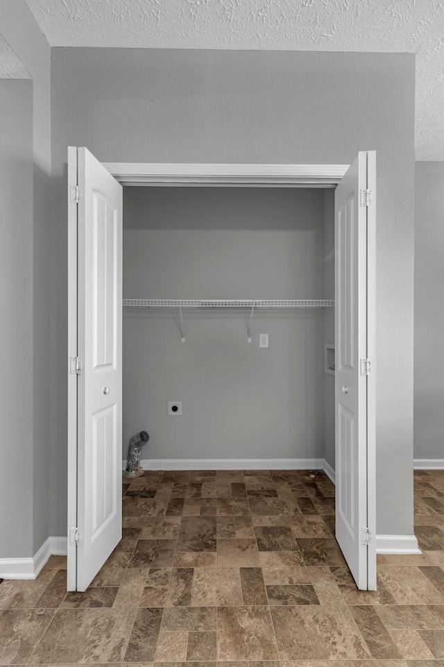 laundry area with washer hookup, a textured ceiling, and hookup for an electric dryer