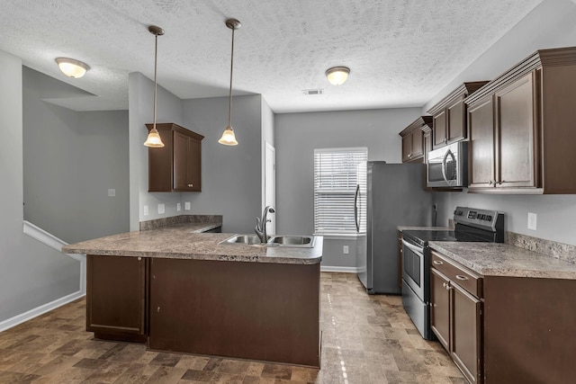 kitchen with decorative light fixtures, kitchen peninsula, sink, dark brown cabinetry, and stainless steel appliances