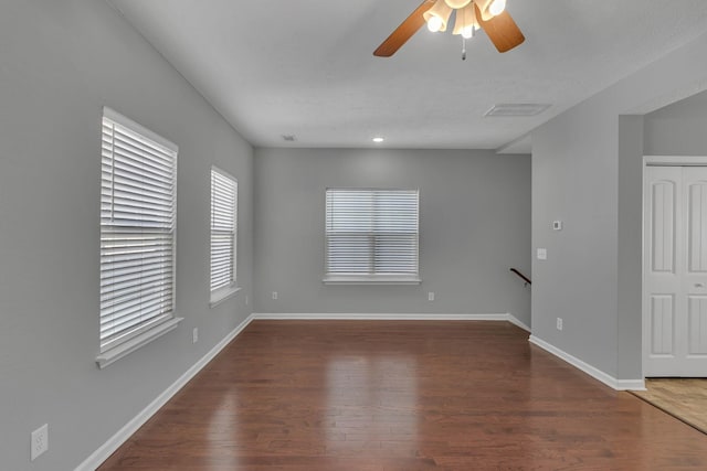 spare room featuring ceiling fan and dark wood-type flooring