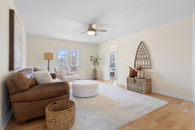 living room featuring light hardwood / wood-style floors and ceiling fan