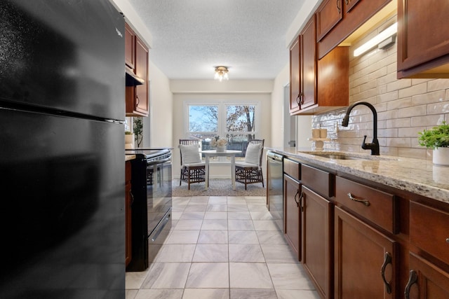 kitchen with tasteful backsplash, black appliances, sink, a textured ceiling, and light stone counters