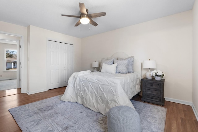 bedroom featuring ceiling fan, hardwood / wood-style flooring, and a closet