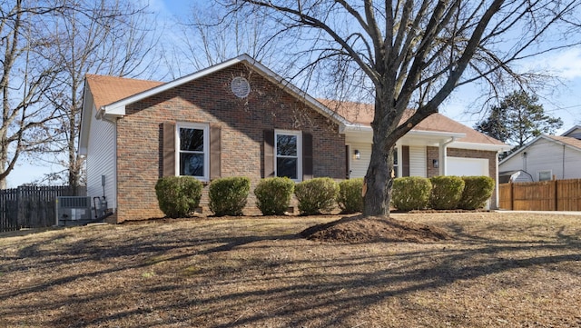 view of front of property with a garage and cooling unit