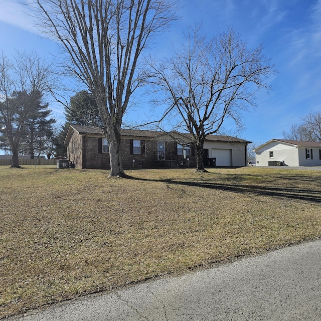 single story home with a garage and a front yard