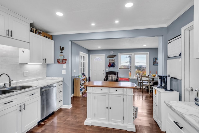 kitchen with dishwasher, white cabinetry, dark hardwood / wood-style flooring, decorative backsplash, and sink