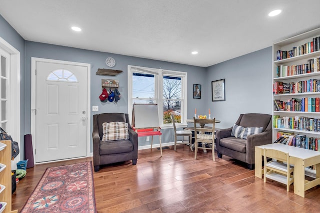 living area with hardwood / wood-style flooring