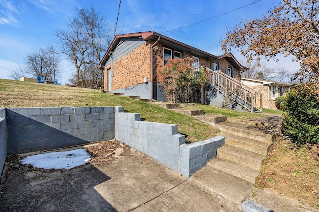 view of side of home featuring a yard