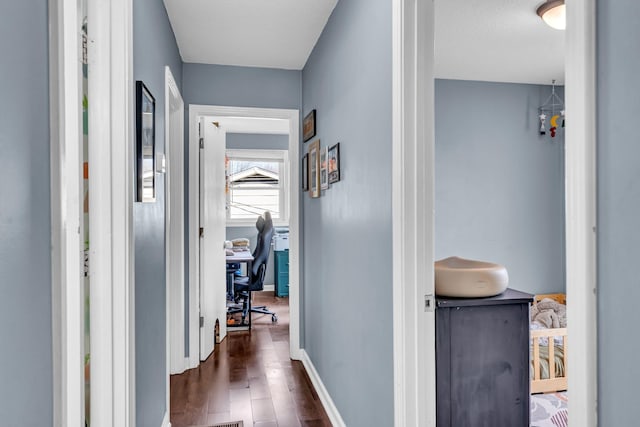 hallway with dark hardwood / wood-style floors