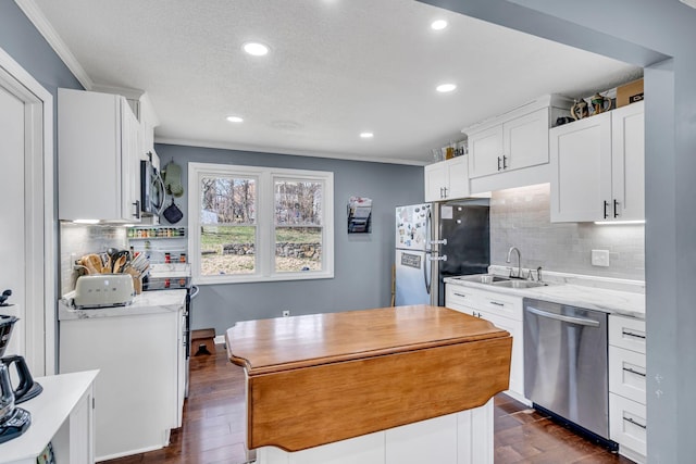 kitchen featuring white cabinets, dark hardwood / wood-style floors, stainless steel appliances, and tasteful backsplash