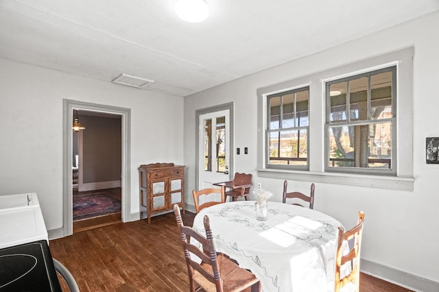 dining space with dark hardwood / wood-style floors