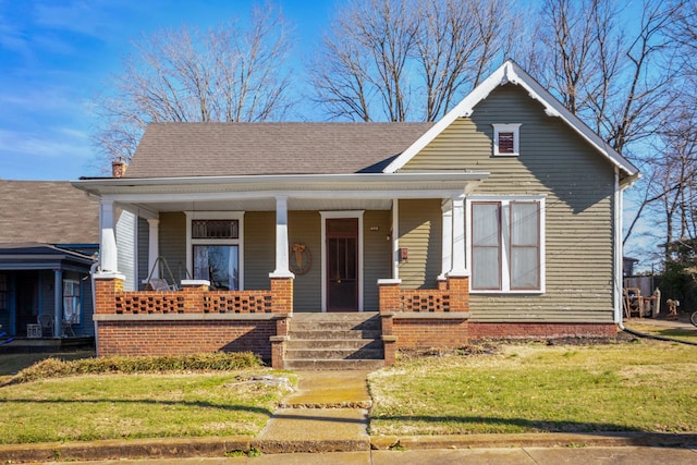 view of front of house with a front lawn and a porch