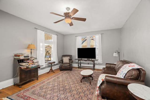 living room with ceiling fan and hardwood / wood-style floors