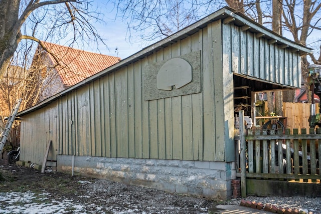 view of side of home featuring an outbuilding