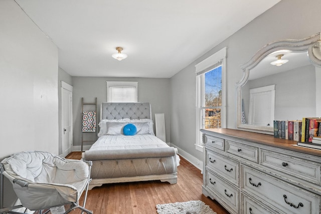 bedroom with light wood-type flooring and multiple windows