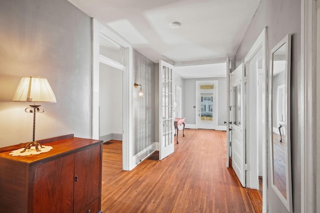 corridor featuring french doors and hardwood / wood-style flooring