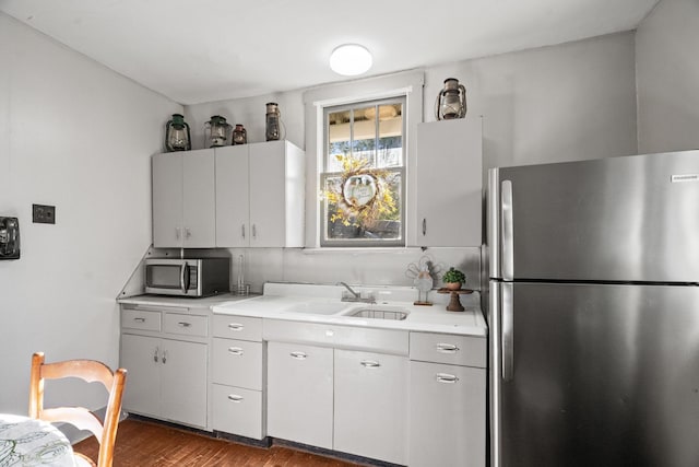 kitchen featuring white cabinets, dark hardwood / wood-style flooring, sink, and stainless steel appliances