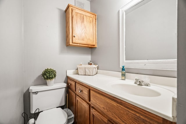 bathroom with toilet and vanity