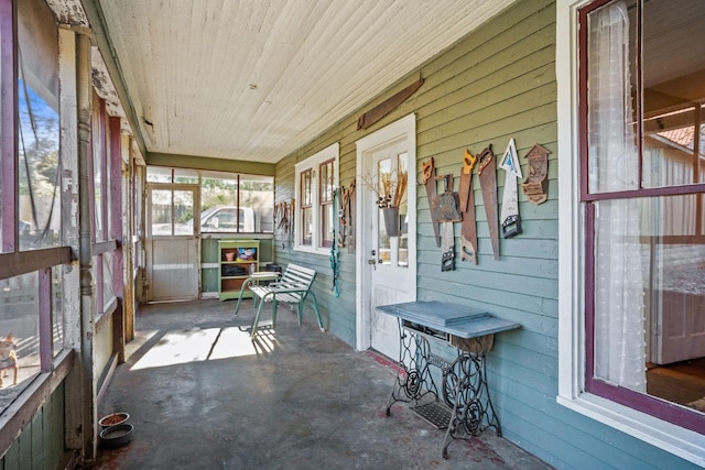 unfurnished sunroom with wood ceiling