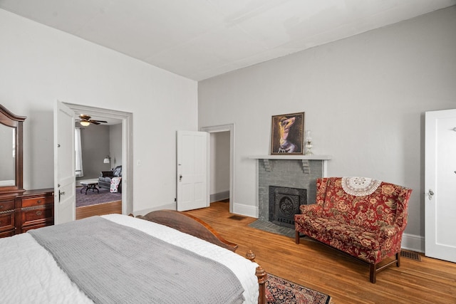 bedroom featuring a fireplace and hardwood / wood-style flooring