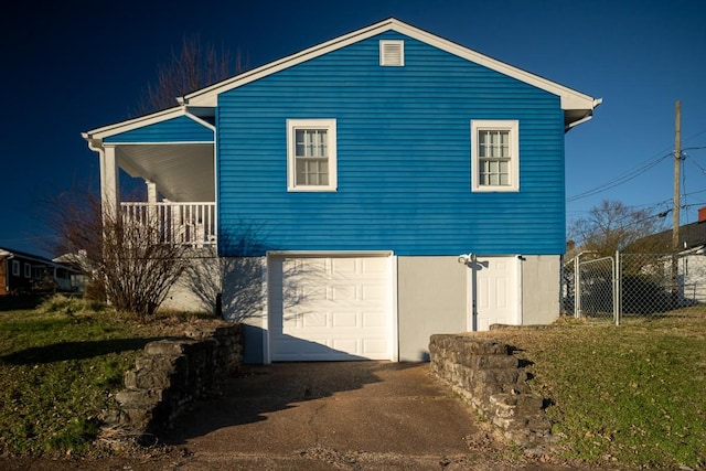 view of side of home with a garage and a lawn