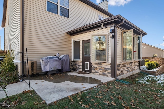 back of property with a patio