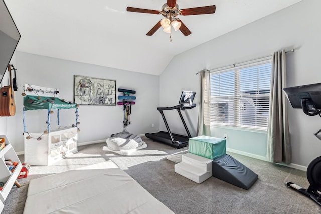 exercise room with ceiling fan, vaulted ceiling, and carpet