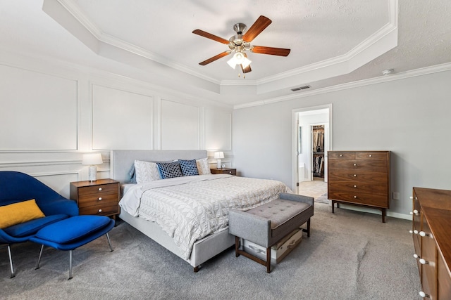 bedroom with a raised ceiling, ceiling fan, a spacious closet, and a closet