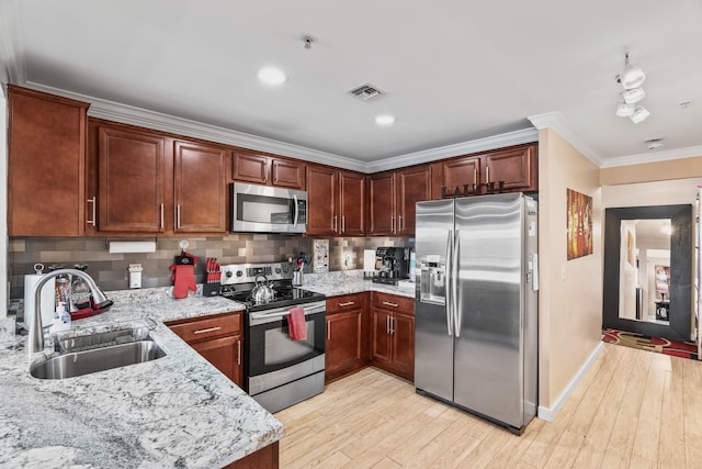 kitchen with decorative backsplash, sink, crown molding, light stone countertops, and appliances with stainless steel finishes