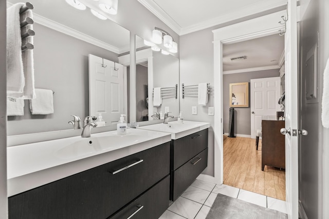 bathroom with tile patterned floors, vanity, and crown molding