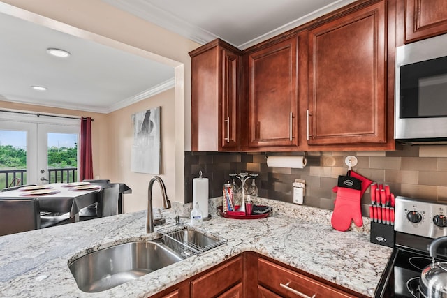 kitchen featuring backsplash, sink, crown molding, stainless steel appliances, and french doors