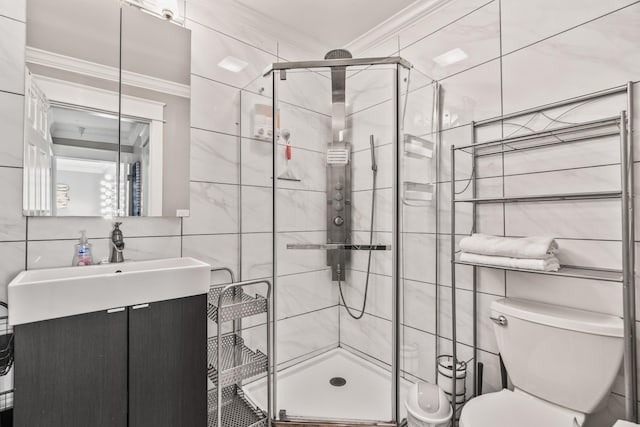 bathroom featuring toilet, ornamental molding, a shower with door, and vanity