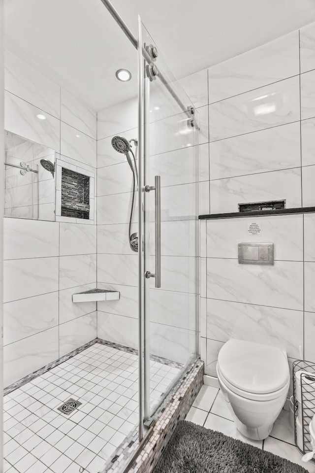 bathroom featuring toilet, tile patterned flooring, and a shower with door