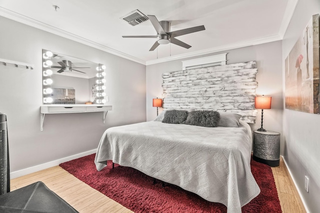 bedroom with ceiling fan, crown molding, and hardwood / wood-style flooring